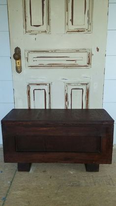 a wooden bench sitting in front of a door