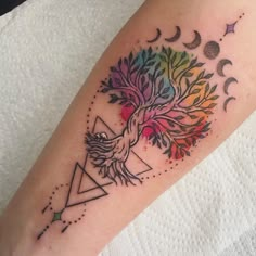 a colorful tattoo on the arm of a woman with an eagle and tree in it