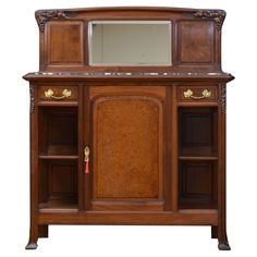 an old fashioned wooden cabinet with mirror on top