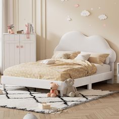 a child's bedroom with a white bed and teddy bear