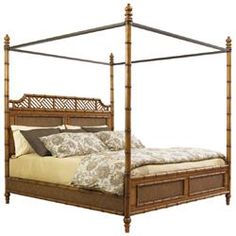 a four poster bed with wooden posts and pillows on it's sides, against a white background