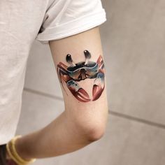 a person with a crab tattoo on their arm