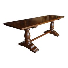 a wooden table with two legs and a long slab on one end, against a white background