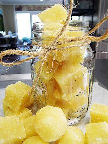 a glass jar filled with cut up pineapples on top of a kitchen counter