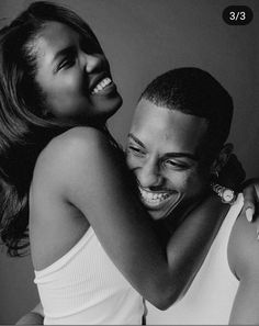 a black and white photo of a man hugging a woman