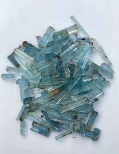 small pieces of glass sitting on top of a white surface