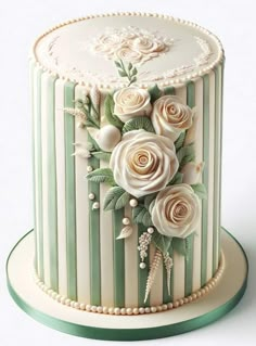 a white and green striped cake with flowers on it