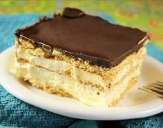 a piece of cake sitting on top of a white plate with a fork next to it