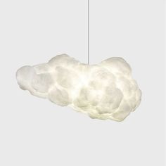 a cloud shaped light hanging from a ceiling