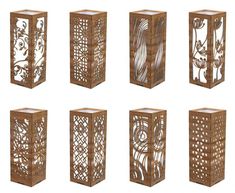 six wooden vases with intricate designs on the sides, all in different shapes and sizes