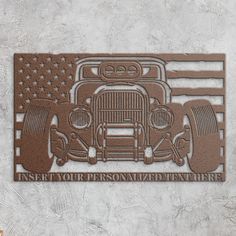 a metal plaque with an old car and american flag