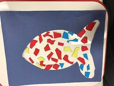 a paper plate with an image of a fish in red, white and blue on it