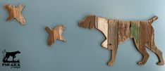 two wooden dogs are hanging on the wall