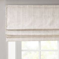 a white roman blind in front of a window