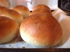 six rolls sitting on top of a baking sheet