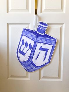 a blue and white door hanger with the number seventy on it