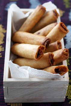 some food is in a wooden box on a table