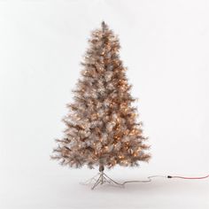 a white christmas tree with lights on it and a red cord attached to the base