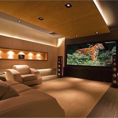 a home theater with couches and a projector screen