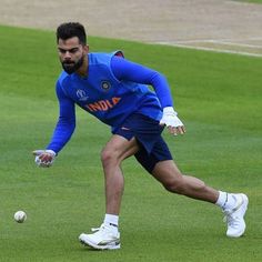 a man in blue jersey catching a ball on field