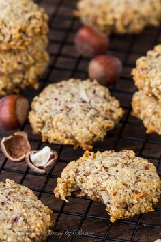 some cookies are cooling on a rack with nuts and other food items around the edges