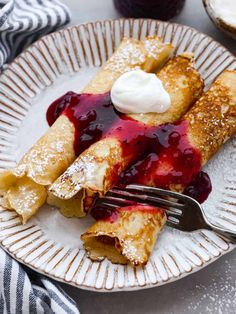 crepes with blueberry sauce and whipped cream on top