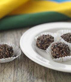 three chocolate truffles on a white plate