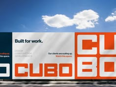 an advertisement for cubbo is displayed on the side of a building with clouds in the background