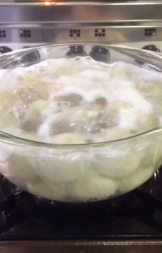 a bowl filled with food sitting on top of an oven