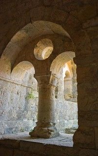 an arch in the side of a building with stone pillars and arches on either side