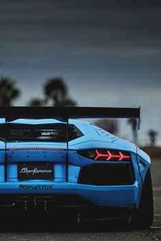 a blue sports car parked in a parking lot