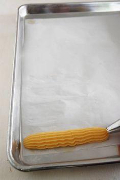 a person is using a spatula to make something yellow