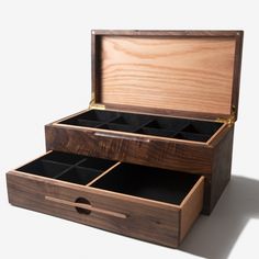 an open wooden box with several compartments