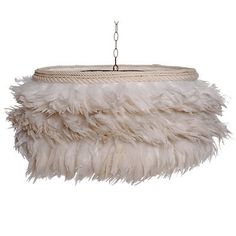 a white feather lamp hanging from a ceiling