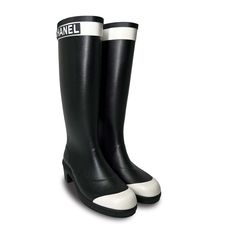 Walking your dog or going for a stroll in the park is now a glamourous event with these stunning Chanel Designer rain boots. Constructed from black rubber, these designer boots feature the Chanel logo wrapped around the top in a white band and are finished with a white toe cap. As part of the 2019 collection, these designer rain boots are now a rare find and stand out more than an all black equivalent. Add your wardrobe and walk in style with these amazing rain boots and stride with Chanel class Chanel Rain Boots, Designer Rain Boots, White Rain Boots, Walking Your Dog, Chanel Designer, Ysl Shoes, Jimmy Choo Sunglasses, Chanel Logo, White Caps