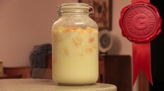 a glass jar filled with liquid sitting on top of a table