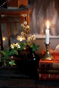 a candle and some books on a table