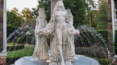 a fountain with two statues in front of it