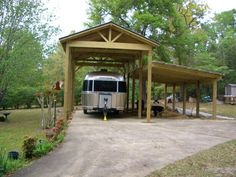 an rv is parked under a covered carport