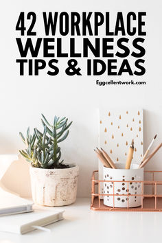 a white desk topped with a potted plant next to a cup filled with pens and pencils