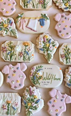 many decorated cookies are arranged on a table