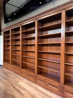 an empty bookcase in the middle of a room