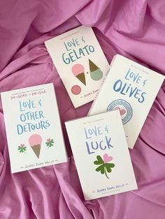 three love and other detours books are laying on a pink bed sheet with the covers pulled down