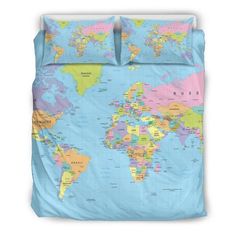 a map of the world on a bed with blue sheets and pillow cases, all in different colors