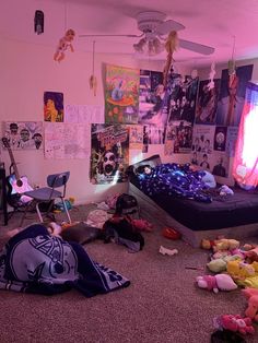 a messy bedroom with lots of stuffed animals on the floor