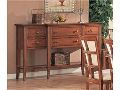 a wooden desk and chairs in a room