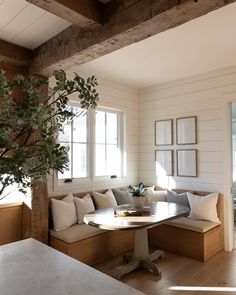 a living room filled with furniture and a tree in the corner on top of a table