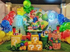 a mario birthday party with balloons and decorations