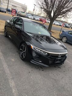 a black car is parked in the parking lot