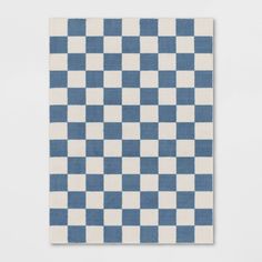 a blue and white checkered rug on a wall